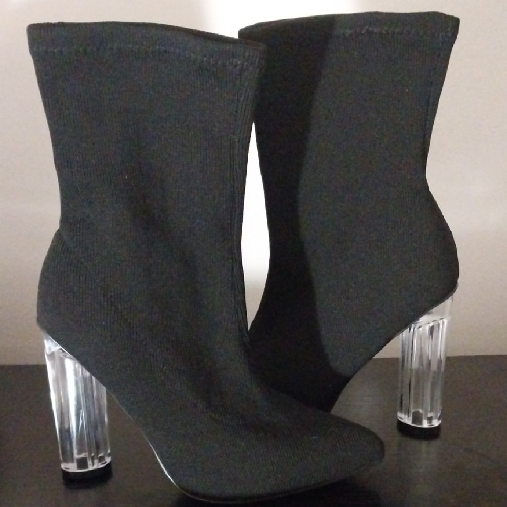 Black Heeled Boots with Transparent Heels and Sleek Silhouette